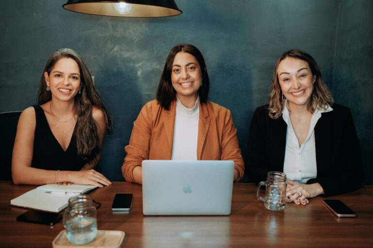 Smiling Colleagues Sitting at Table